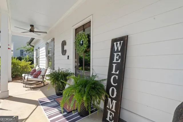 a view of sign board with potted plants