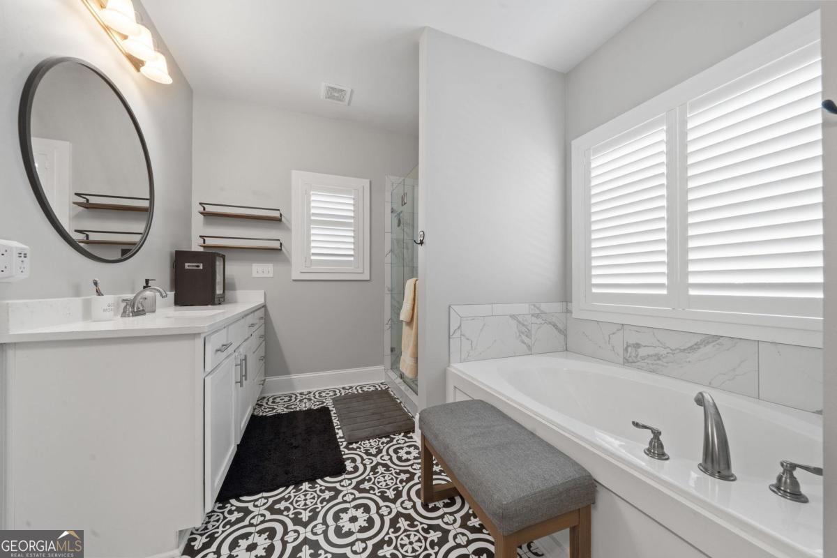 757 Markhams Drive Madison, GA 30650 - Photo 32 of 46 a bathroom with a tub sink and mirror
