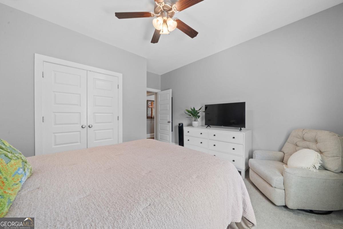 757 Markhams Drive Madison, GA 30650 - Photo 38 of 46 a bedroom with a bed and a flat screen tv