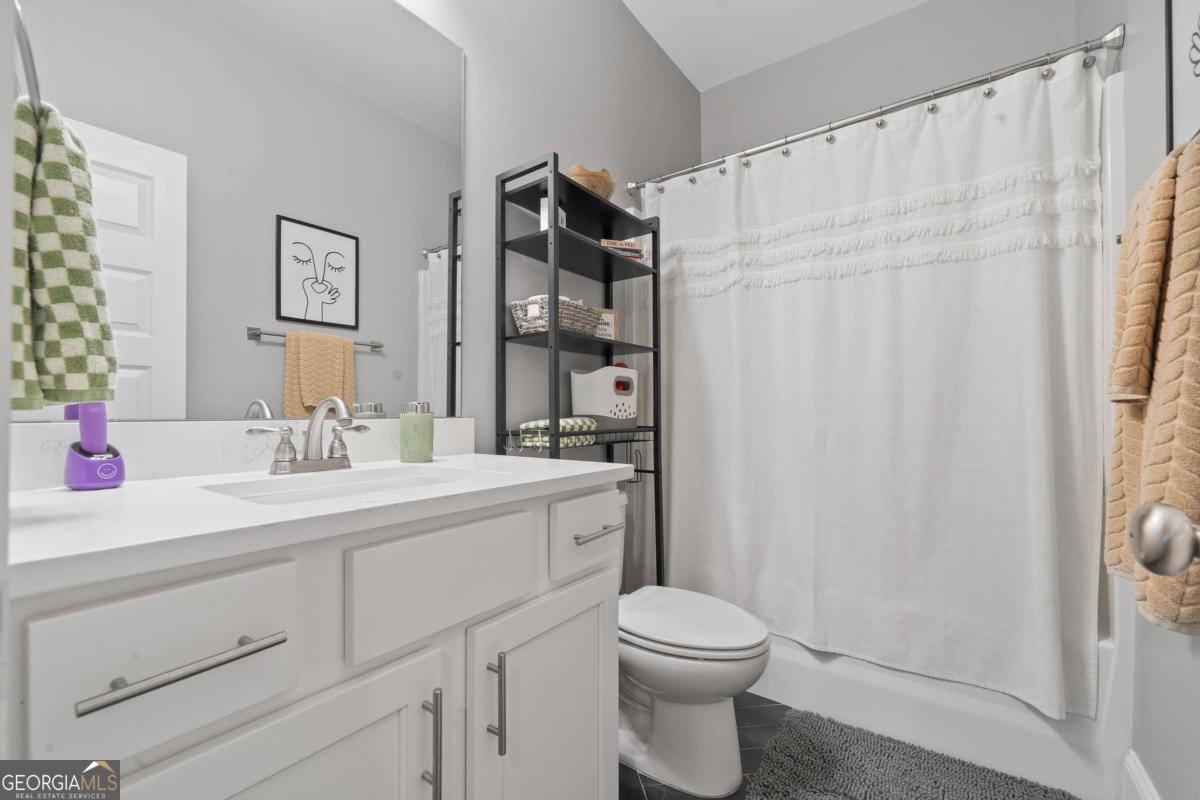 757 Markhams Drive Madison, GA 30650 - Photo 39 of 46 a bathroom with a sink a toilet and shower curtain