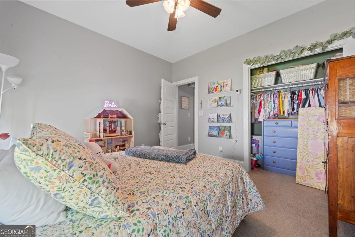 757 Markhams Drive Madison, GA 30650 - Photo 41 of 46 a bedroom with a bed and a walk in closet