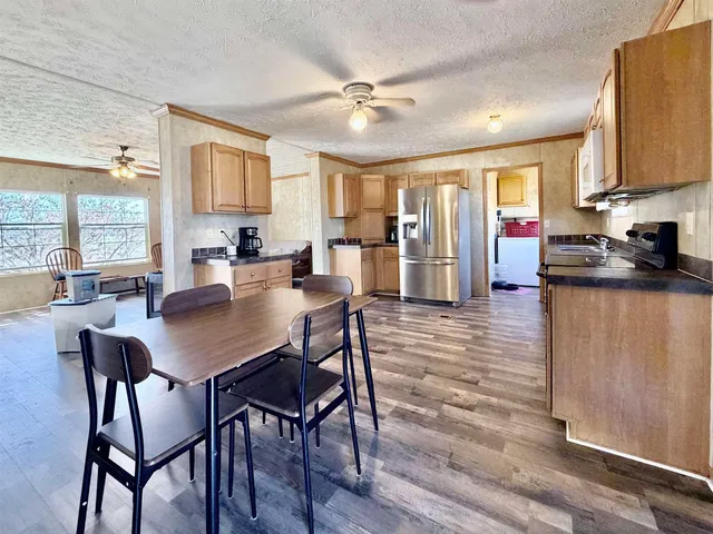 a view of a dining room with furniture and a chandelier
