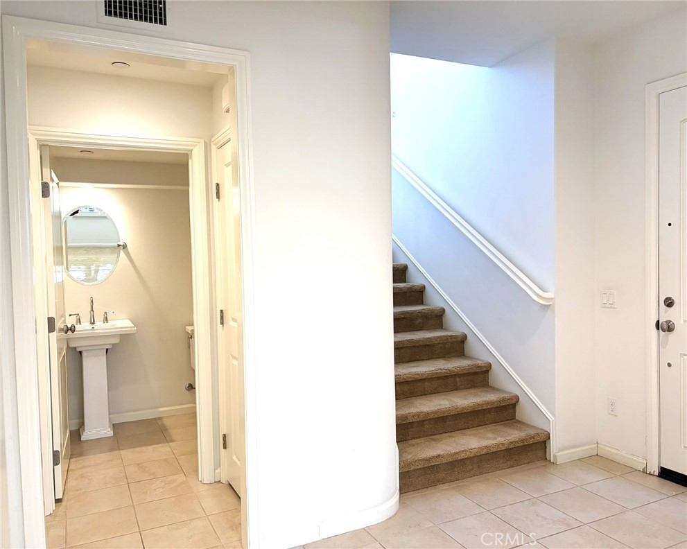 178 Working Ranch Irvine, CA 92602 - Photo 3 of 42 a view of a hallway with wooden floor and entryway