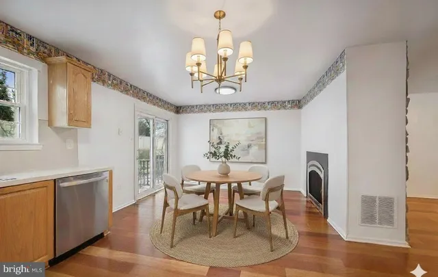 a kitchen with stainless steel appliances granite countertop a refrigerator a sink dishwasher a stove with wooden cabinets