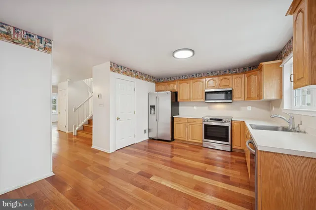 a view of empty room with a fireplace and wooden floor