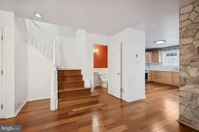 a view of a room with wooden floor and white walls
