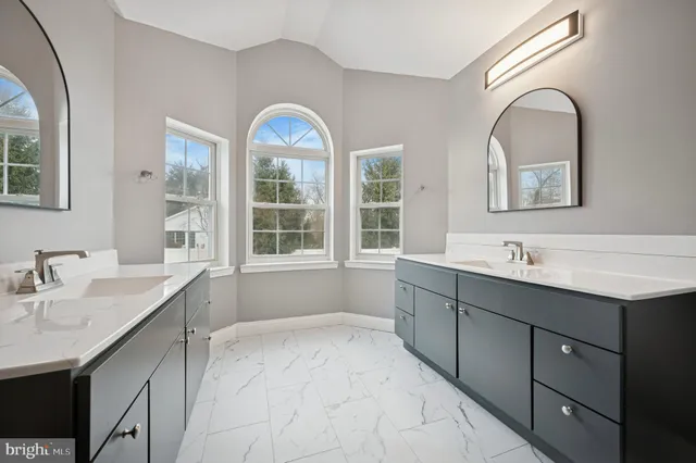 a spacious bathroom with a bathtub sink and mirror