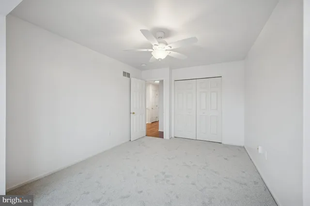 a bedroom with a bed and a ceiling fan
