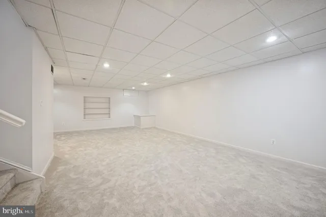 a living room with furniture gym equipment and a potted plant