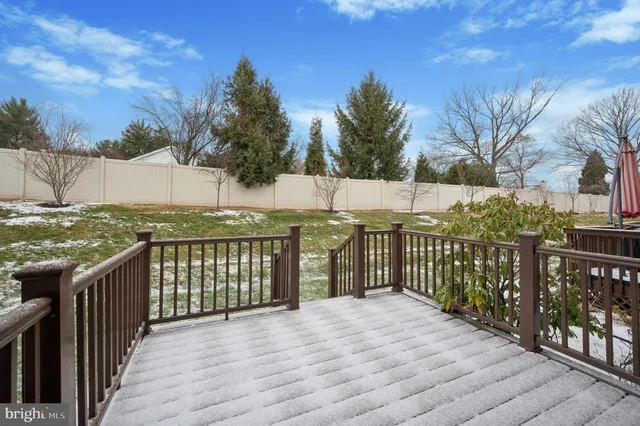 a view of a balcony with wooden floor and fence