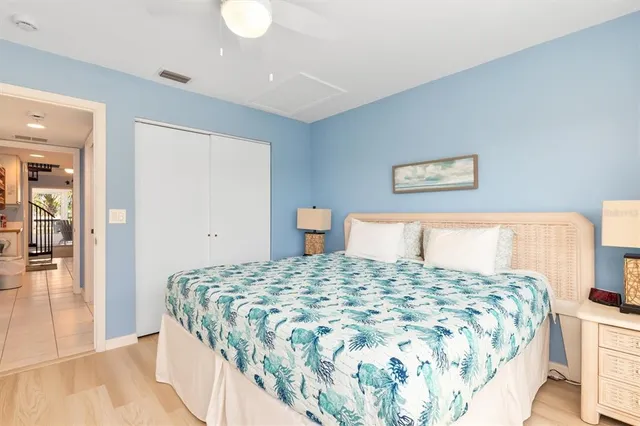 a bedroom with a large bed and a chandelier