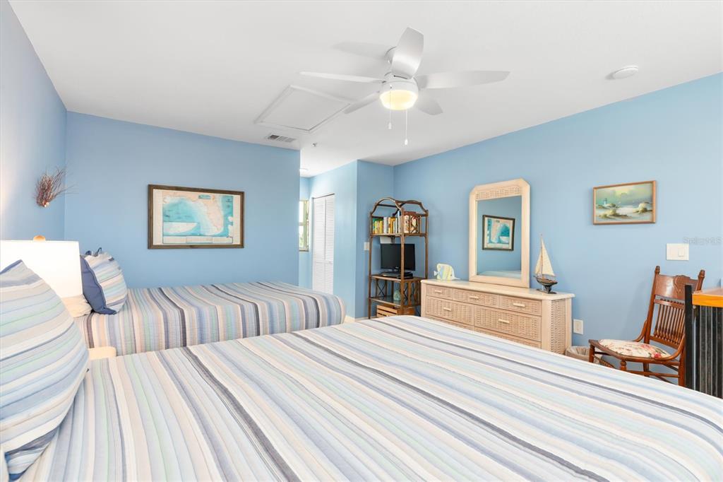 9400 Little Gasparilla, Unit H2 Placida, FL 33946 - Photo 21 of 47 a bedroom with double bed and a chandelier