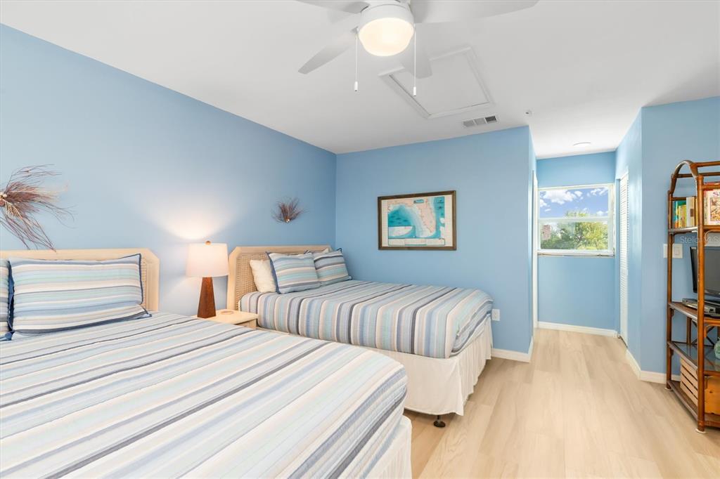 9400 Little Gasparilla, Unit H2 Placida, FL 33946 - Photo 22 of 47 a bedroom with two beds and a chandelier