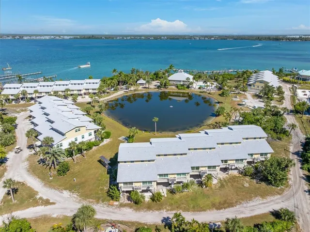 an aerial view of a house with a yard and lake view