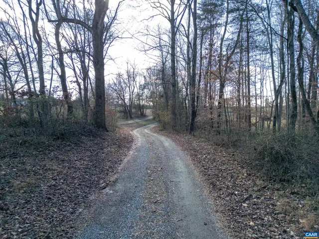 a kitchen with stainless steel appliances granite countertop a refrigerator a sink and a stove with wooden floors