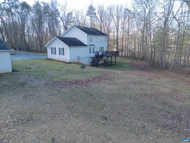 a view of a dry yard with wooden fence