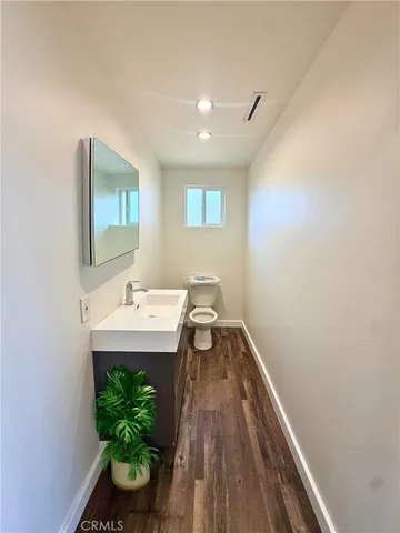 a view of a hallway to a livingroom with furniture