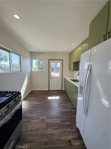 a kitchen with a refrigerator and a stove