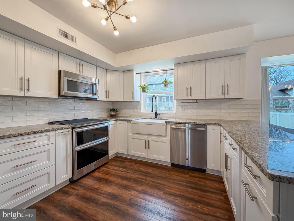 738 Bridgeview Road Feasterville-Trevose, PA 19053 - Photo 14 of 54 a kitchen with stainless steel appliances granite countertop a stove a sink and white cabinets