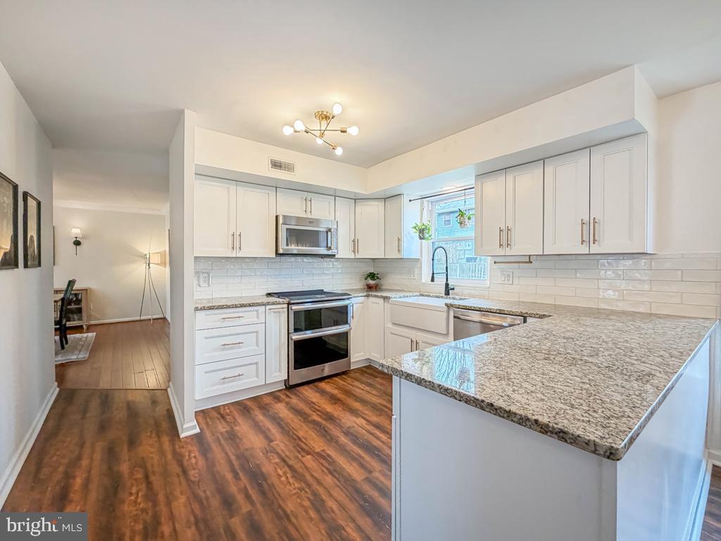 738 Bridgeview Road Feasterville-Trevose, PA 19053 - Photo 15 of 54 a kitchen with granite countertop a sink cabinets and stainless steel appliances