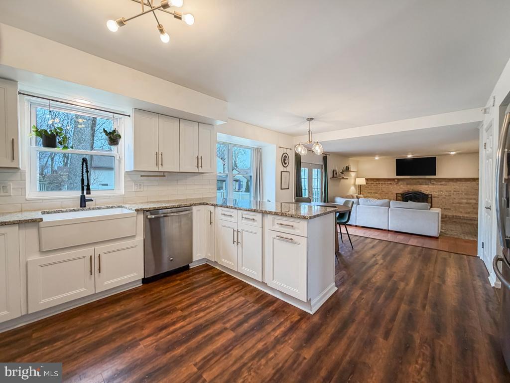 738 Bridgeview Road Feasterville-Trevose, PA 19053 - Photo 18 of 54 a kitchen with wooden floors and white appliances