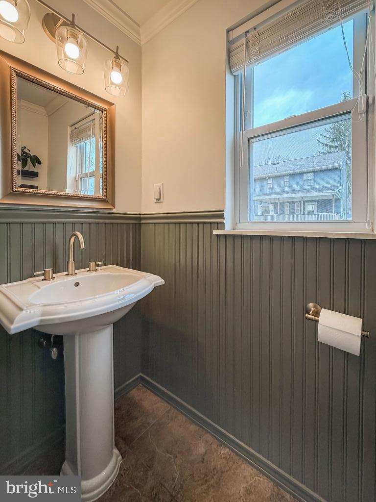 738 Bridgeview Road Feasterville-Trevose, PA 19053 - Photo 28 of 54 a bathroom with a sink a mirror and a window