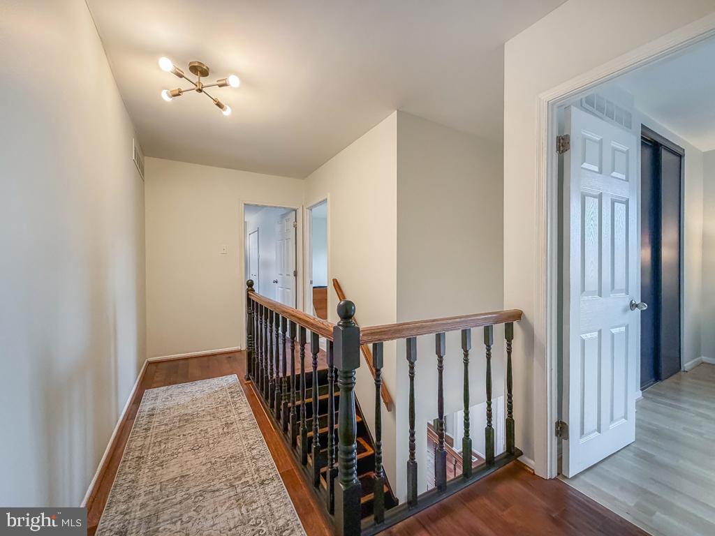 738 Bridgeview Road Feasterville-Trevose, PA 19053 - Photo 30 of 54 a view of a hallway with wooden floor and stairs