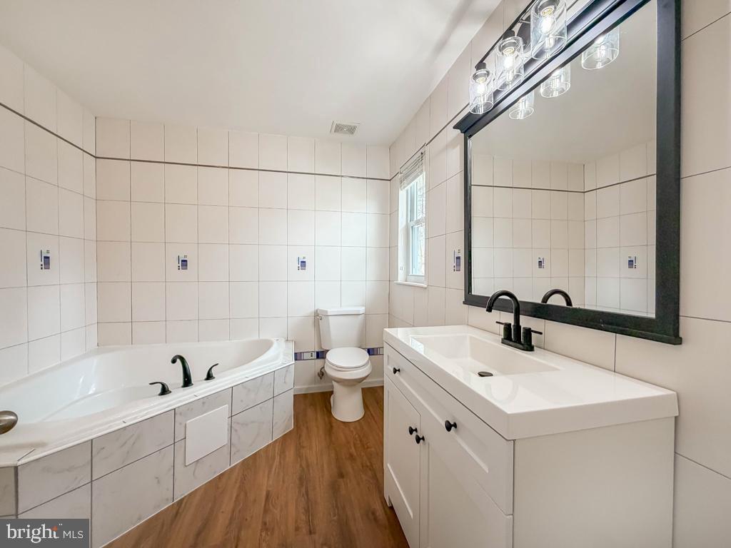 738 Bridgeview Road Feasterville-Trevose, PA 19053 - Photo 36 of 54 a bathroom with a bathtub a sink a toilet and a mirror