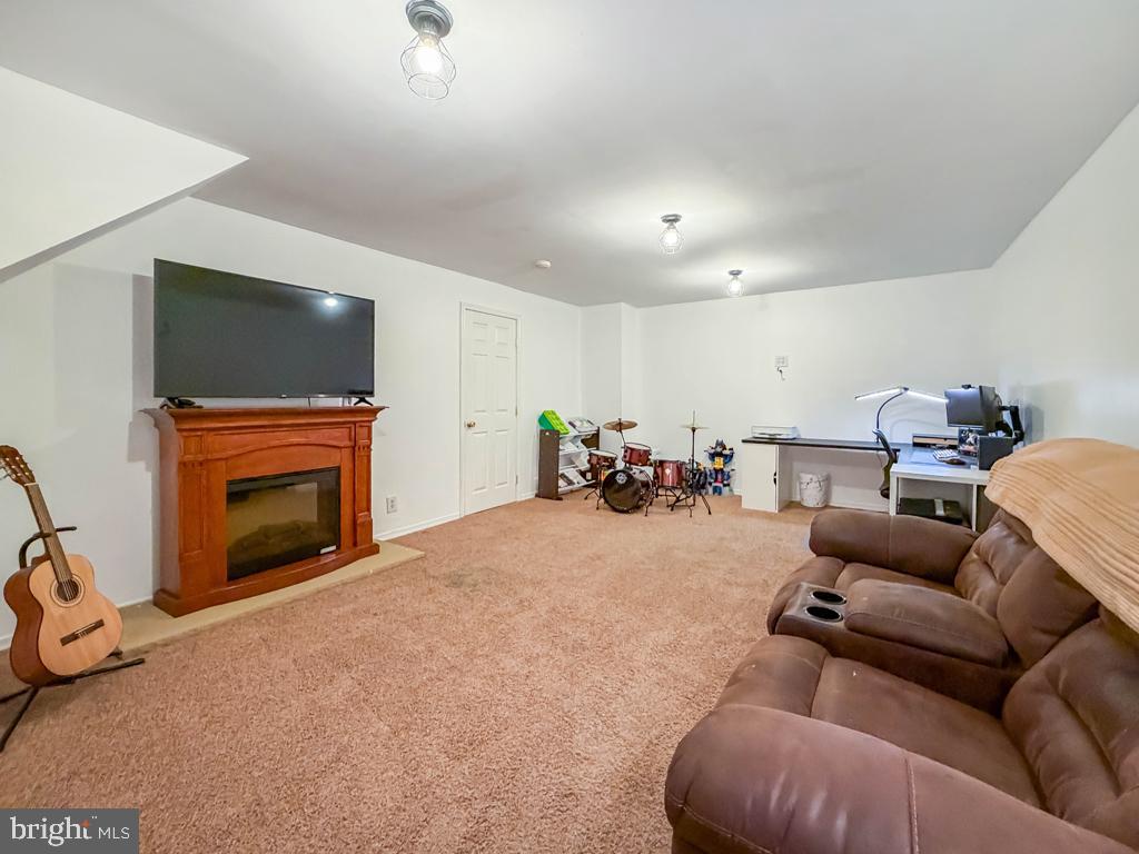 738 Bridgeview Road Feasterville-Trevose, PA 19053 - Photo 46 of 54 a bed room with furniture a flat screen tv and a fireplace