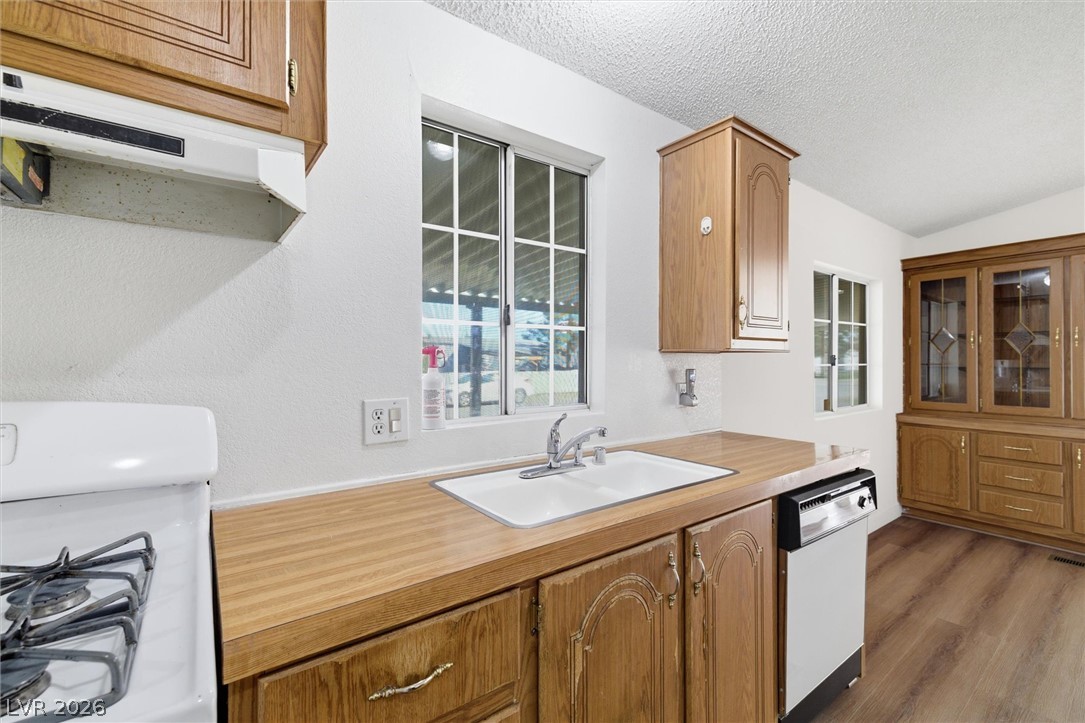 20 Rudy Road Pahrump, NV 89048 - Photo 16 of 32 Laminate countertops and classic wood cabinetry define this functional culinary space.