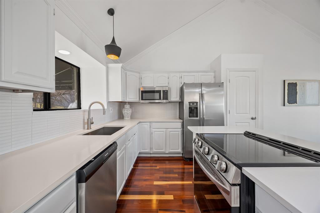 5422 Ranger Drive Rockwall, TX 75032 - Photo 14 of 32 a kitchen with stainless steel appliances granite countertop a sink and a stove