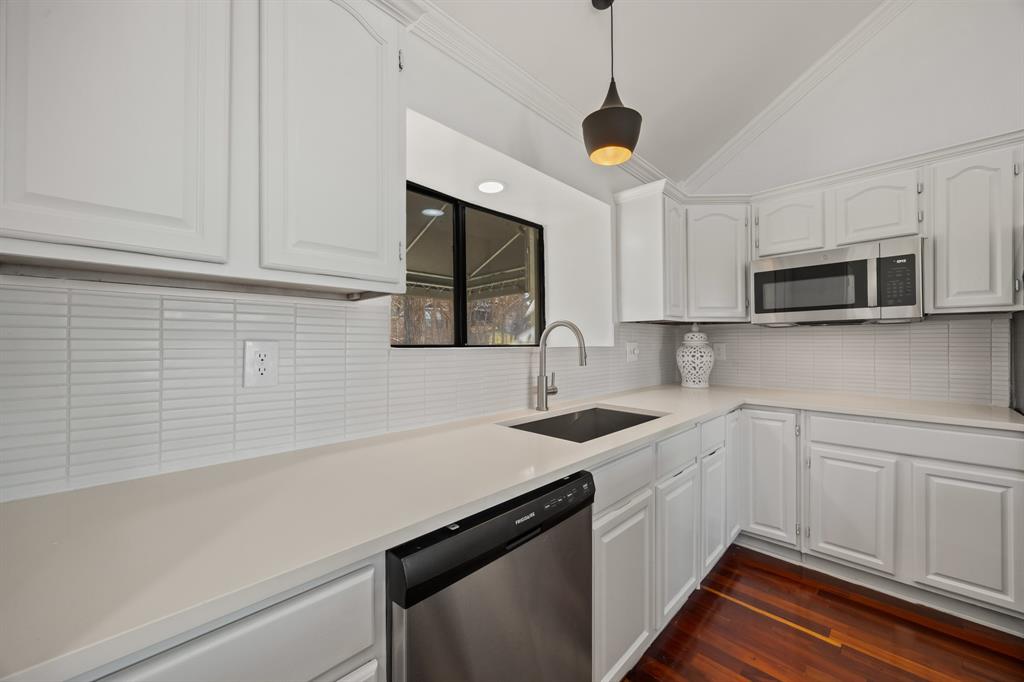 5422 Ranger Drive Rockwall, TX 75032 - Photo 17 of 32 a kitchen with stainless steel appliances a sink a stove and microwave