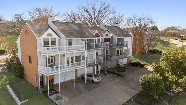 a view of a large white building among the street