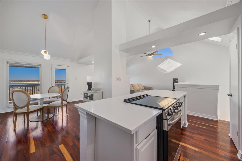 5422 Ranger Drive Rockwall, TX 75032 - Photo 5 of 32 a kitchen with a table chairs stove and wooden floor