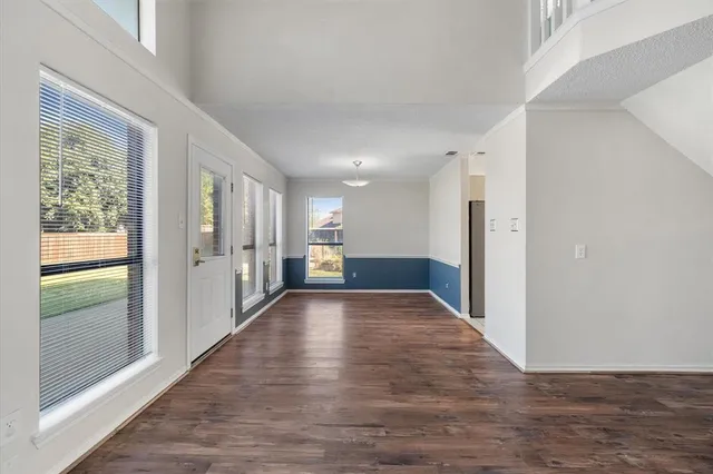 a view of hallway with wooden floor
