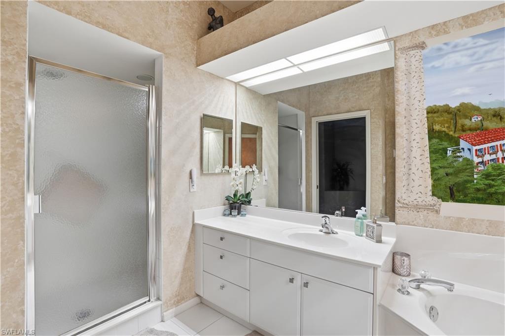 10871 Crooked River Road, Unit 202 Estero, FL 34135 - Photo 26 of 46 a bathroom with a double vanity sink mirror and next to a window