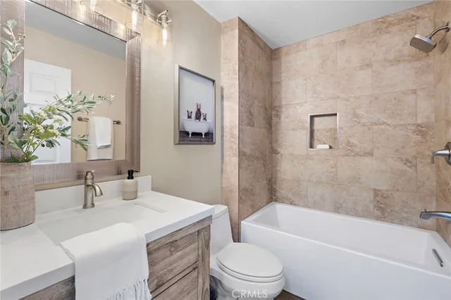 a bathroom with a sink a toilet and bathtub