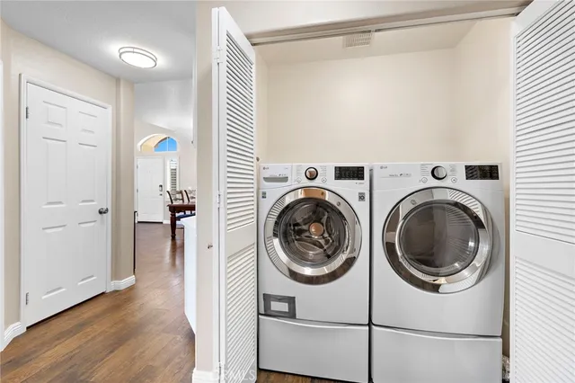 a view of a hallway with washer and dryer