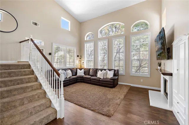 a living room with furniture chandelier and a window