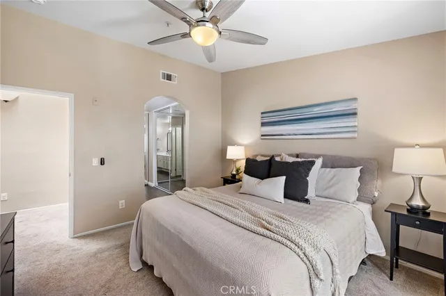 a bedroom with a bed and a chandelier