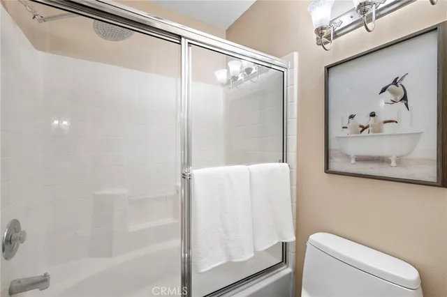 a bathroom with a shower and a toilet