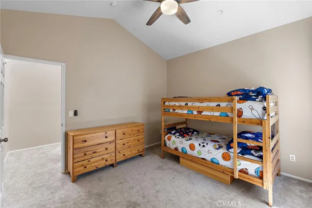 a bedroom with a bed and a baby bed