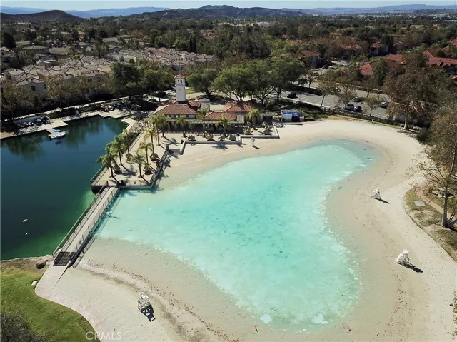 an aerial view of a house with a yard and lake view