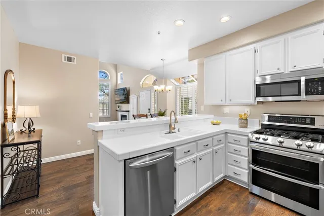 a kitchen with a sink stove and cabinets