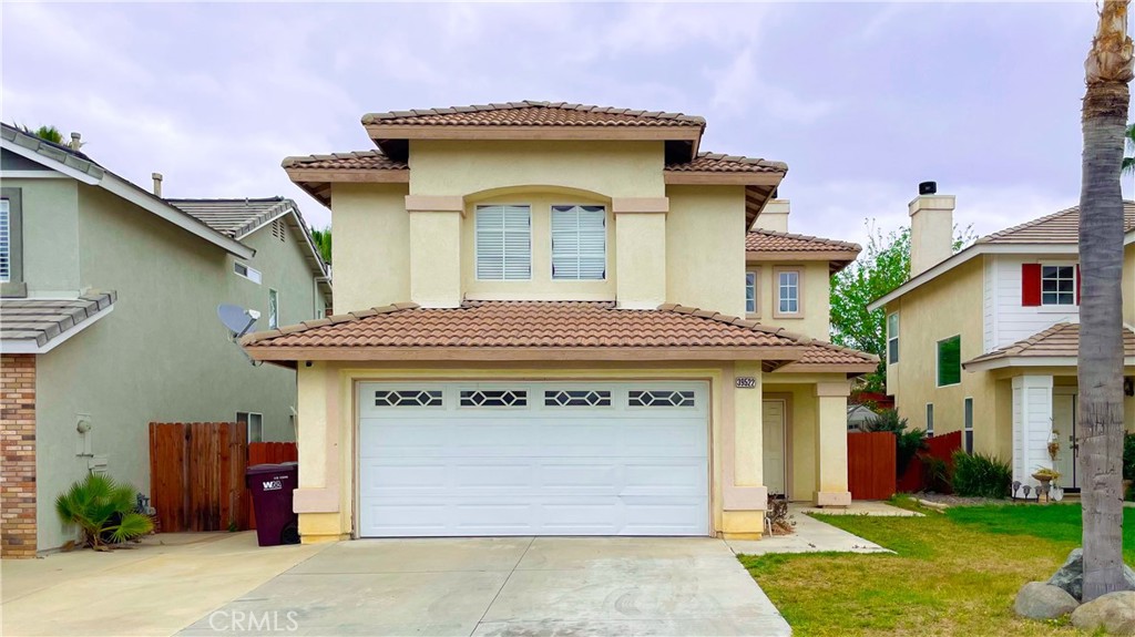 a front view of a house with a yard and garage