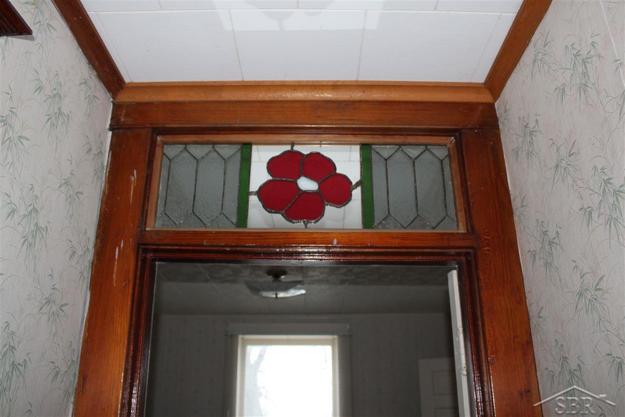 9909 Saginaw Road Reese, MI 48757 - Photo 7 of 12 Stained glass and original wood work add character to master bedroom entry way