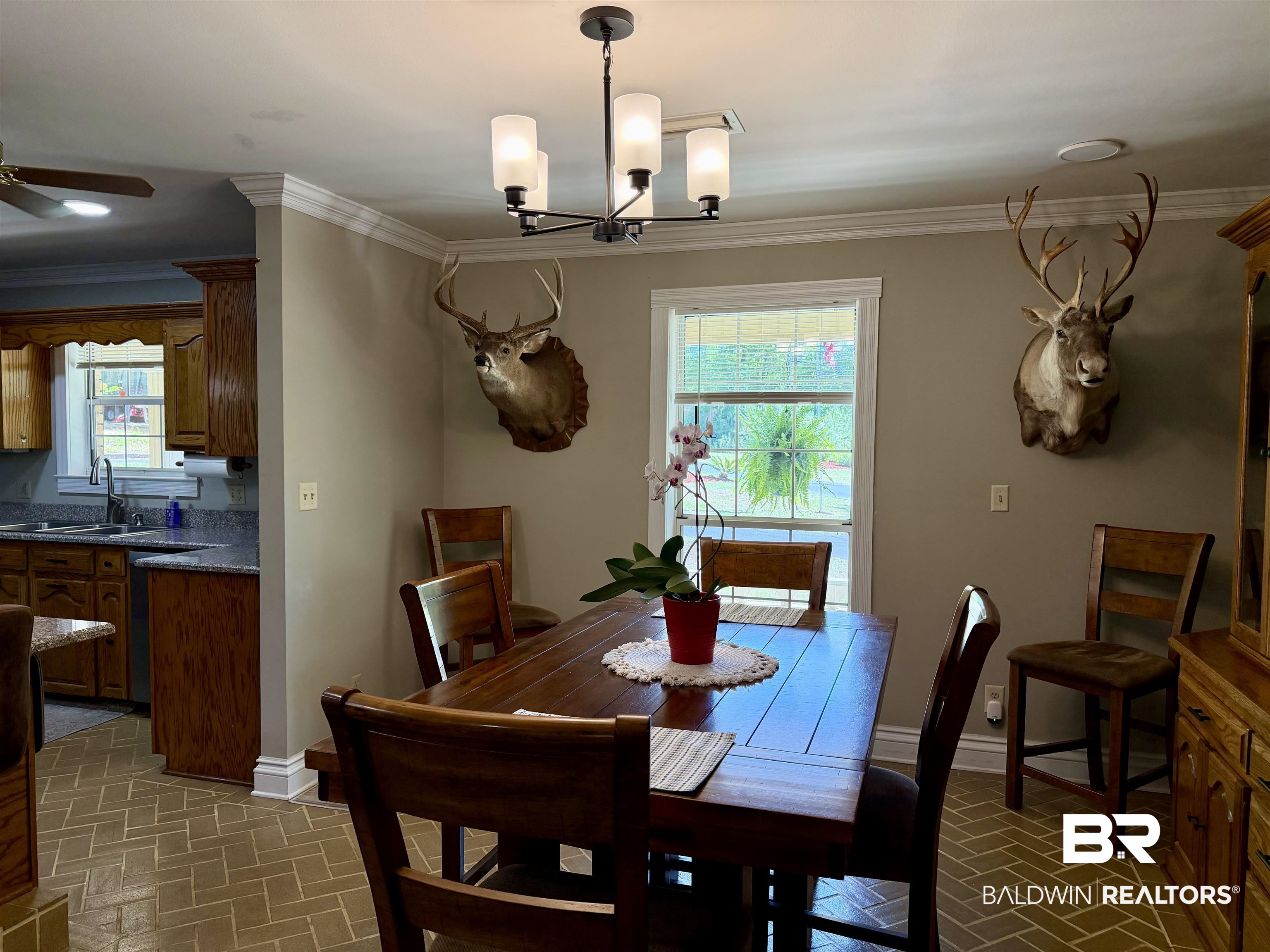 2944 Appleton Road Brewton, AL 36426 - Photo 8 of 65 Dining room featuring brick patterned flooring, ornamental molding, ceiling fan, and a chandelier
