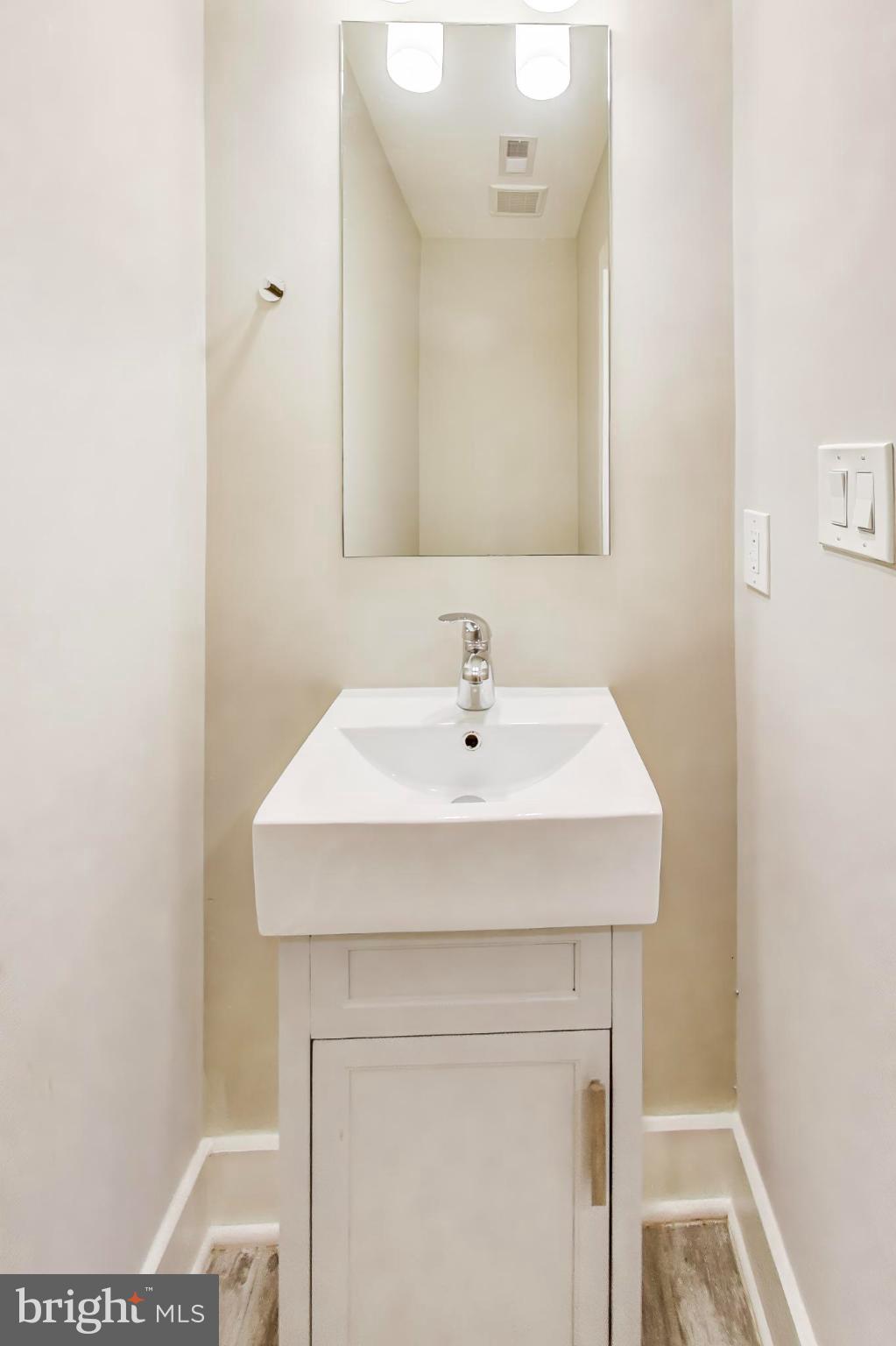 1444 Harvard Street Northwest, Unit 1 Washington, DC 20009 - Photo 15 of 19 Sleek, modern half-bath with minimalist design.