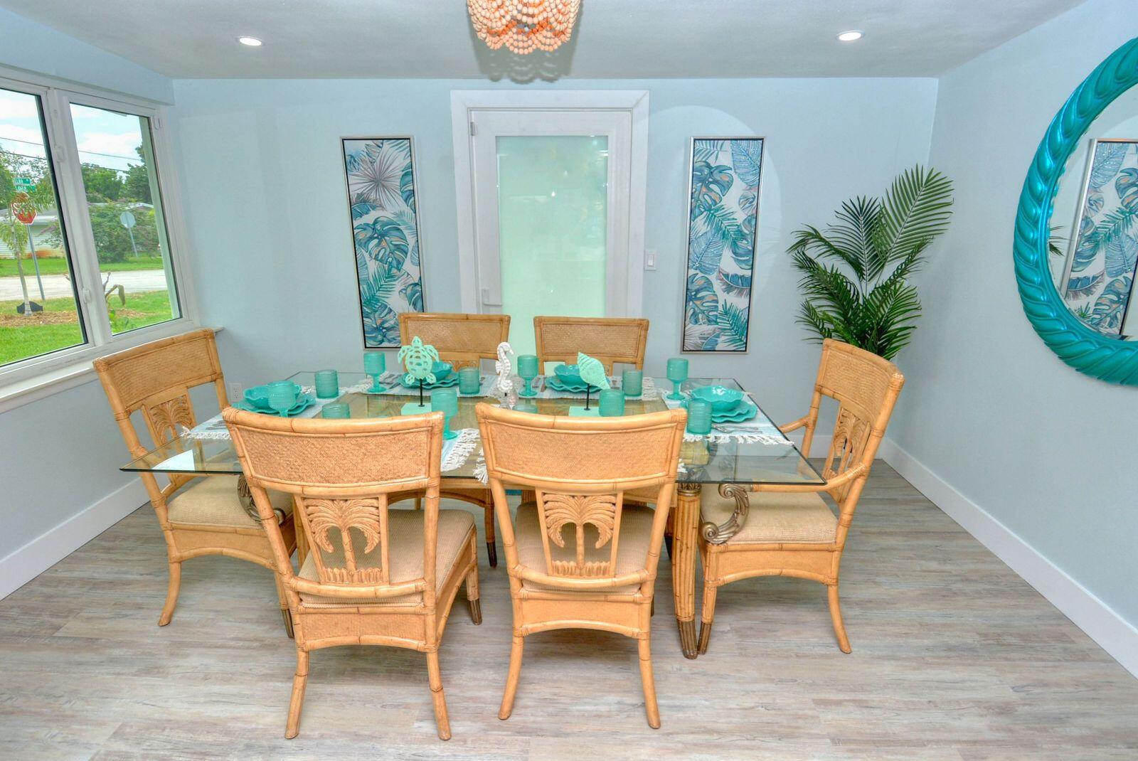 1315 Northeast Flora Place Jensen Beach, FL 34957 - Photo 11 of 27 a view of a dining room with furniture window and wooden floor
