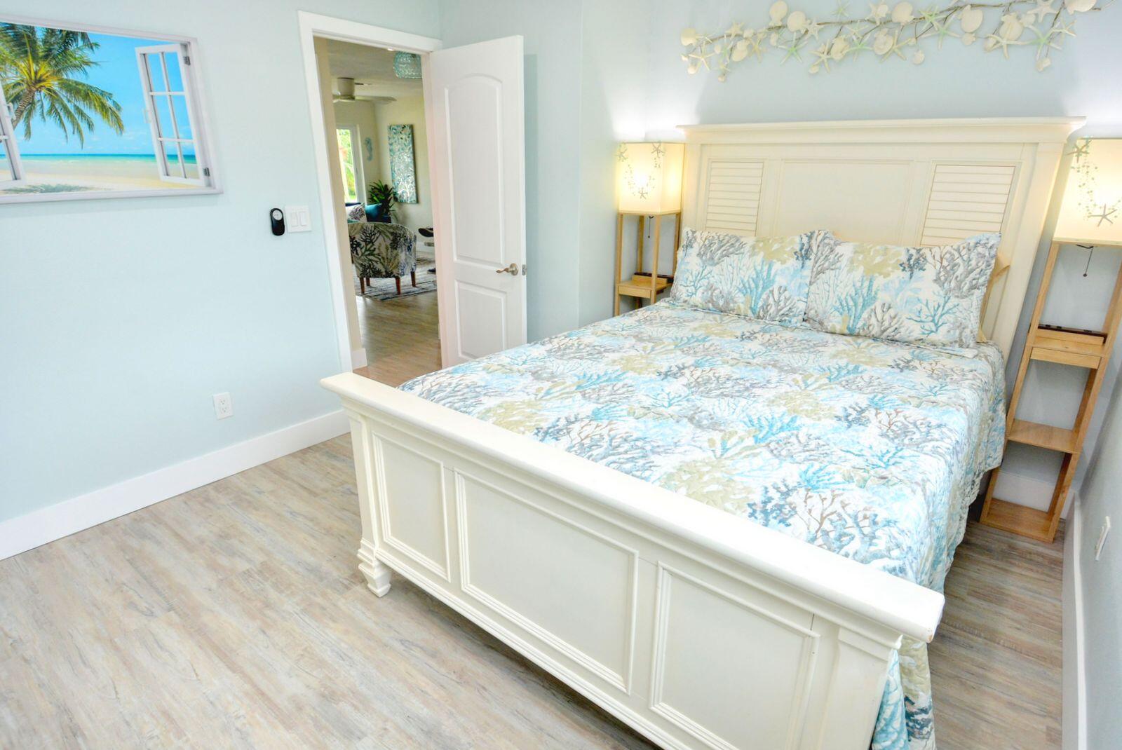 1315 Northeast Flora Place Jensen Beach, FL 34957 - Photo 16 of 27 a room with wooden floor and painting on the wall